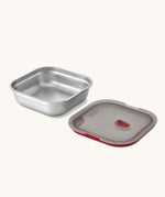 A close up of a Black + Blum square stainless steel leakproof microwave safe lunchbox showing the lid detail