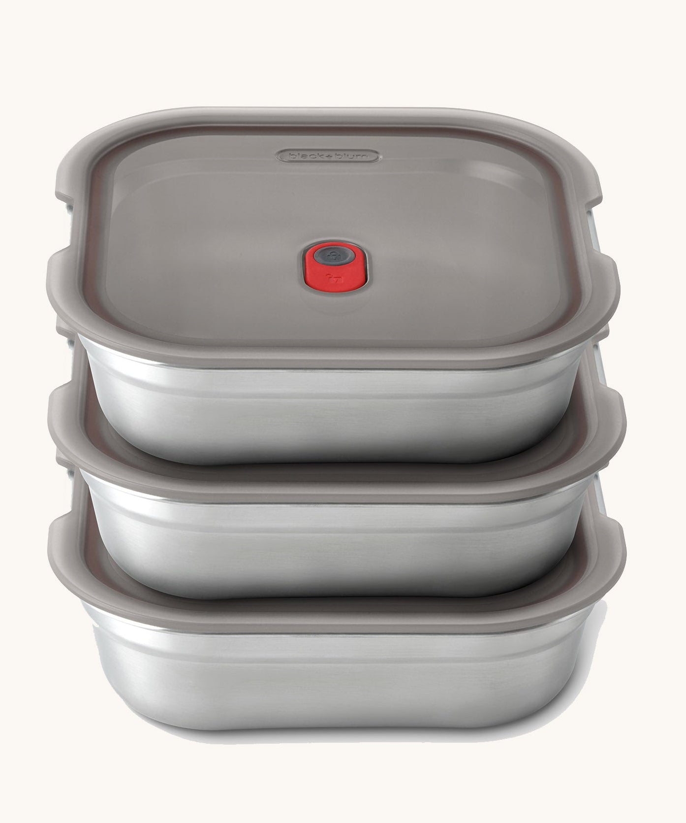 A stack of the Black + Blum square stainless steel leakproof microwave safe lunchboxes