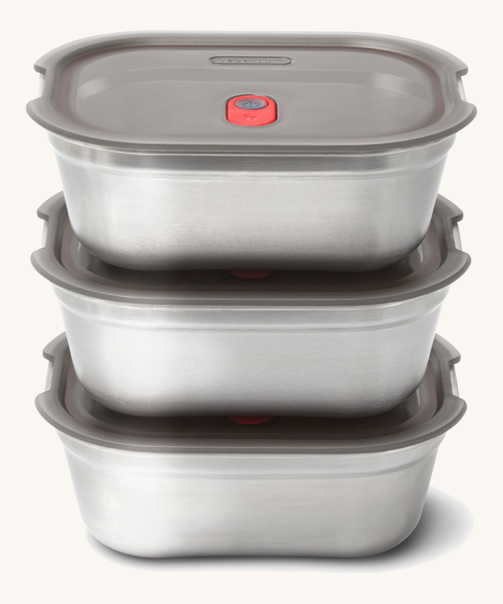 A stack of the stainless steel Black + Blum leakproof lunchboxes.