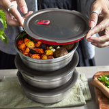 A close up of 3  Black + Blum stainless steel bowls stacked on top of each other on a kitchen worktop