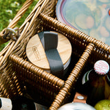 A close up of the Black + Blum stainless steel cups in a picnic basket showing the protective bamboo lid detail