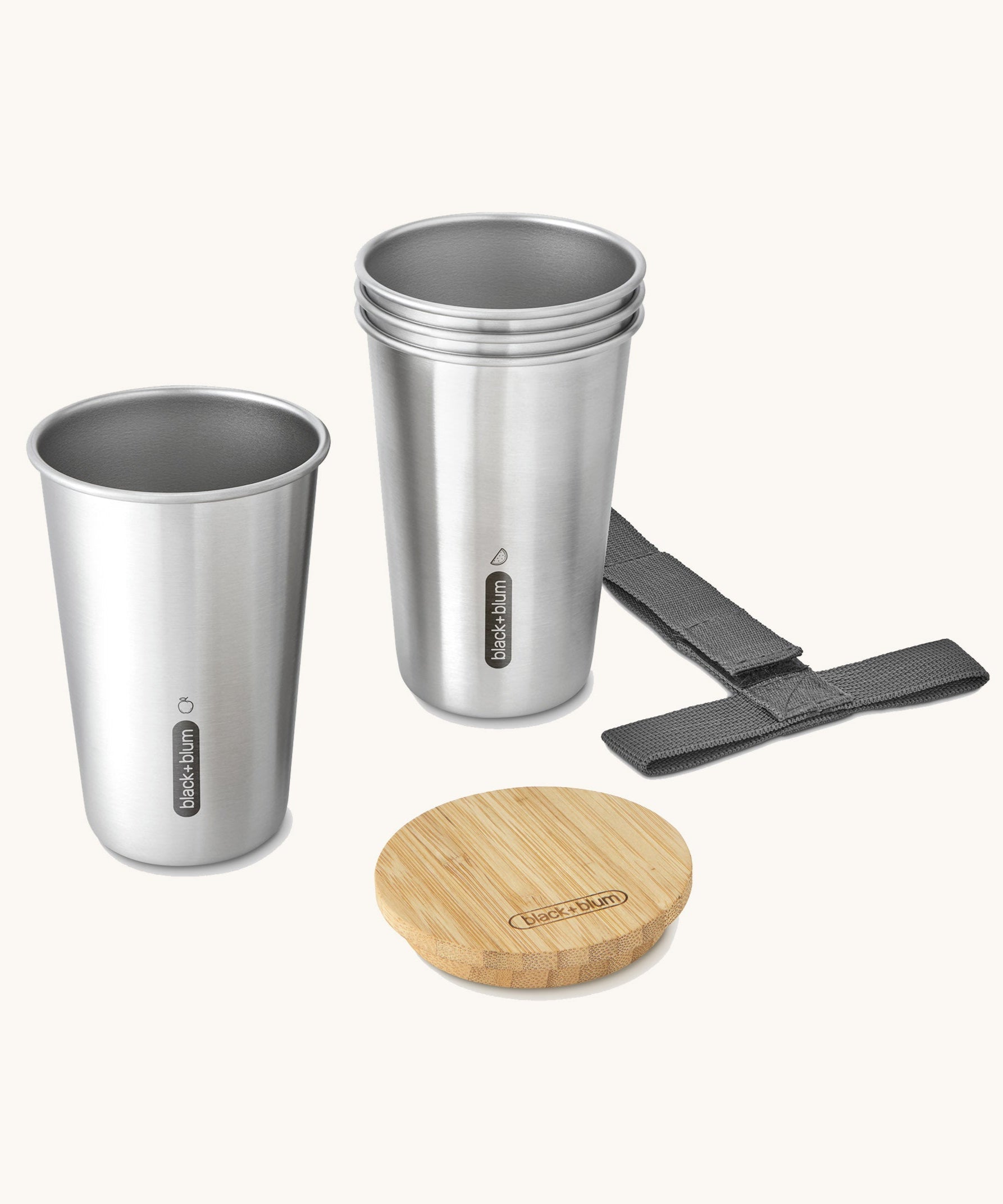 A close up of the set of 4 Black + Blum stainless steel cups showing the bamboo lid bottle opener detail and handy black carry strap
