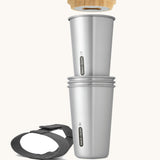 A close up of the set of 4 Black + Blum stainless steel cups showing the  bamboo opener and black carry strap detail