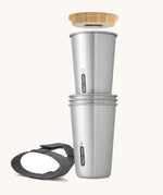 A close up of the set of 4 Black + Blum stainless steel cups showing the  bamboo opener and black carry strap detail