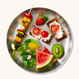 A top down view of the Black + Blum  plates showing various salad and fruit items on the plate