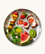 A top down view of the Black + Blum  plates showing various salad and fruit items on the plate
