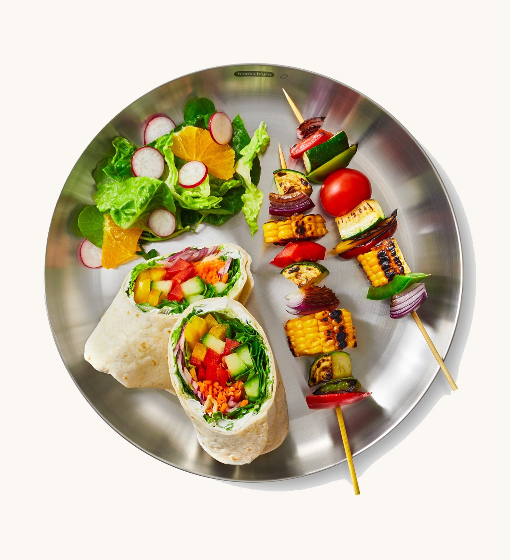 A top down view of the Black + Blum  plates  showing a salad dish on the plate.