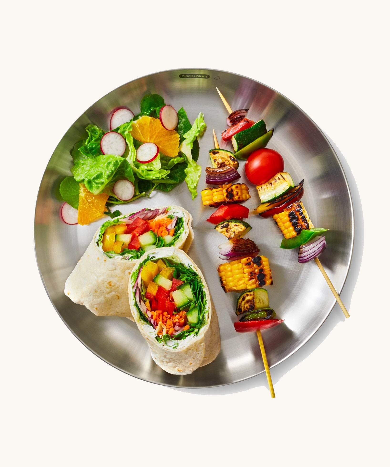 A top down view of the Black + Blum  plates  showing a salad dish on the plate.