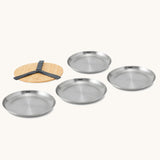 A set of 4 Black + Blum set of  stainless steel plates with a Bamboo protective lid