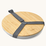 Black + Blum set of 4 stainless steel plates available at Babipur. Features a bamboo protective lid that can be used as a serving plate