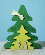 A Bumbu Christmas Tree Nativity Puzzle in the Gold colour way placed on a wooden surface.