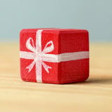A red wooden Bumbu Christmas present.