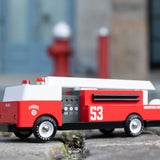 A Candylab Big Red Fire Engine pictured outdoors on a cobbled floor
