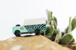 Close up of the Candylab kids wooden jeep toy on a rock next to a mini cactus