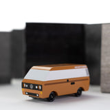 CandyLab Volkswagen T3 Campervan in brown - front view, photographed with a blurred black and white background.