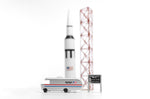 Candylab NASA astro van toy on a white background next to a miniature rocket ship