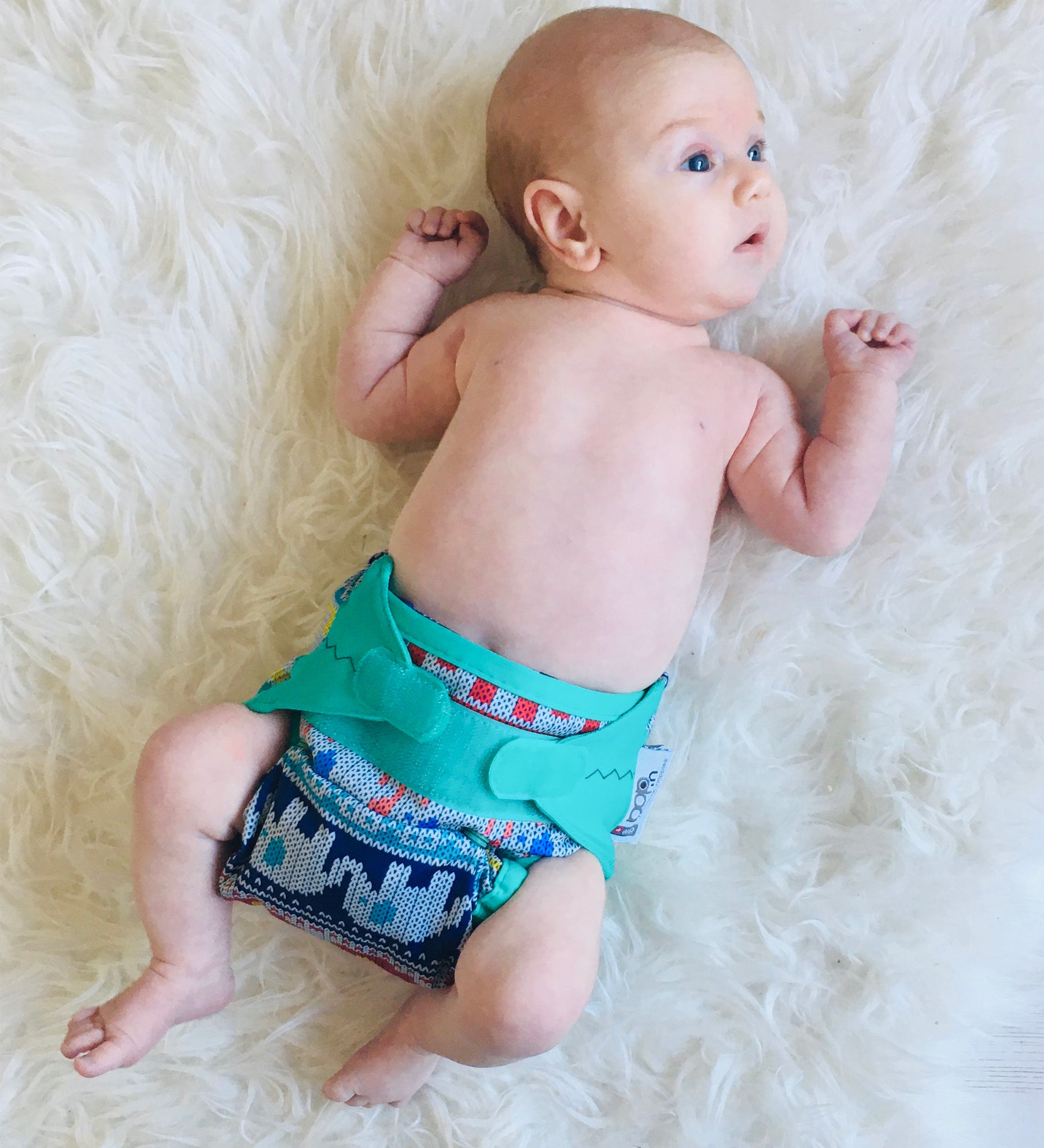 A baby wearing The Close Parent x Babipur exclusive pop-in reusable cloth nappy, in a clyd print