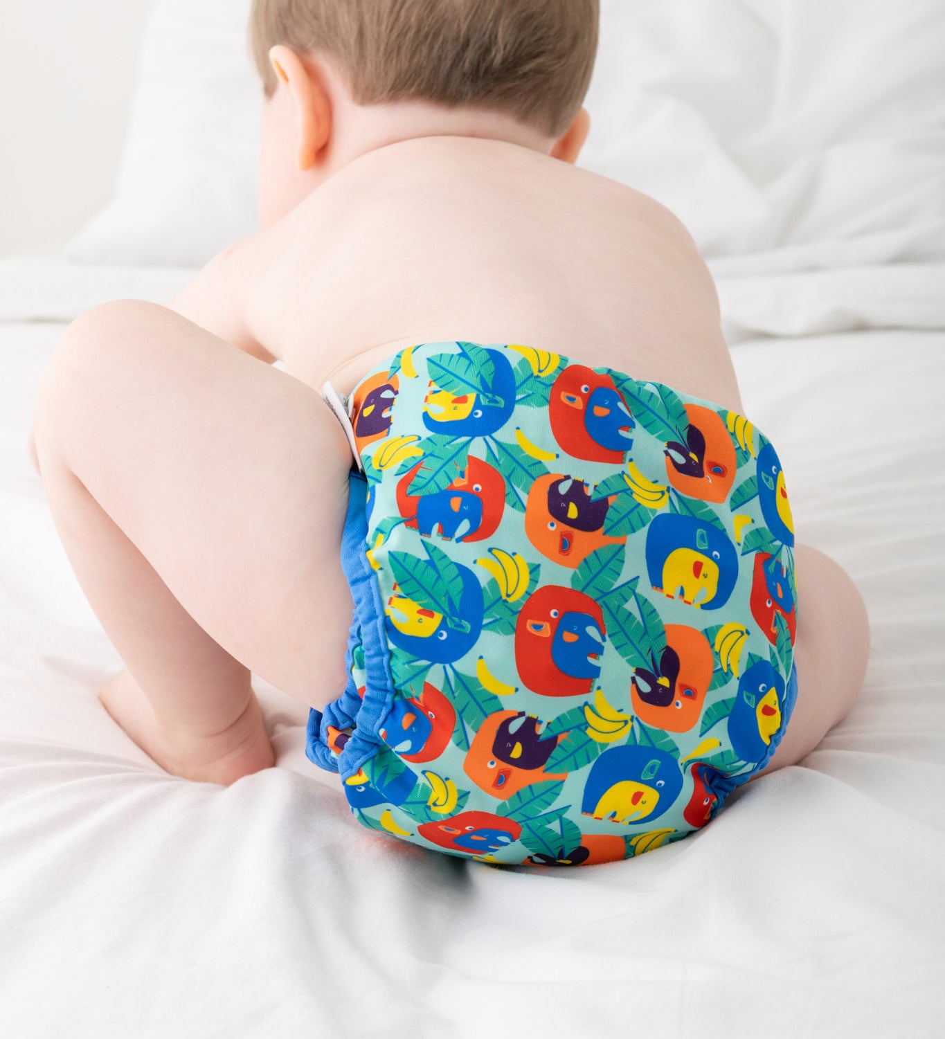 A baby wearing the Close Pop-In x Babipur exclusive reusable nappy wrap, in a Babipur Cwtch print