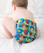 A baby wearing the Close Pop-In x Babipur exclusive reusable nappy wrap, in a Babipur Cwtch print