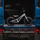 Early rider 12 inch charger balance bike in the back of a blue 4x4 truck