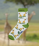Eco kiddies organic cotton white giraffe sock on a background of giraffe in a safari environment.