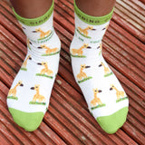 A close up of a child wearing the Eco Kiddies organic cotton giraffe socks showing the cute giraffe design and green trim detail