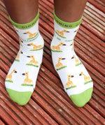 A close up of a child wearing the Eco Kiddies organic cotton giraffe socks showing the cute giraffe design and green trim detail