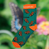 Eco kiddies organic cotton green butterfly sock on a background of a butterfly on a flower