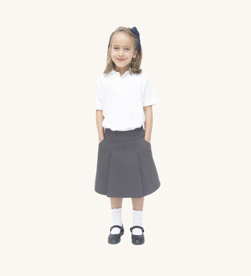 A little girl wearing the Eco Outfitters organic cotton school pleated skirt in grey