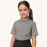 A child wearing a Eco Outfitters Grey coloured Short Sleeves Button-Up School Shirt. The shirt is a part of a wider selection of organic cotton school uniform available at Babipur.