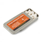 Ecoliving refillable orange flavour toothpaste tablets tin open on a white background showing the white tablets inside