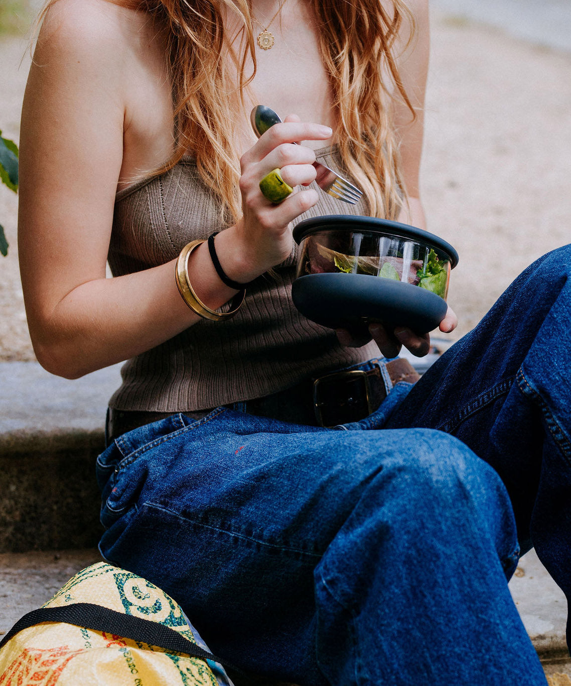 A close up of a woman holding the large Elephant box bowl. Bowl available at Babipur. Features a removable lid and a silicone base.