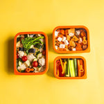 Three sizes of the Elephant Box Prep & Store food storage containers, with orange silicone seals and see through glass lids.