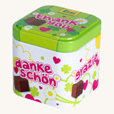 Erzi wooden chocolate cubes in a tin on a cream background.