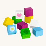 Erzi opened wooden chocolate cubes on a cream background.