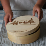 Erzi wooden painted forest toy mushrooms in a round wooden box. A child can be seen lifting the lid off the box.