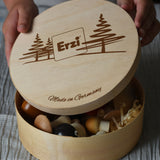 Erzi wooden painted forest toy mushrooms in a round wooden box. A child can be seen lifting the lid off the box.