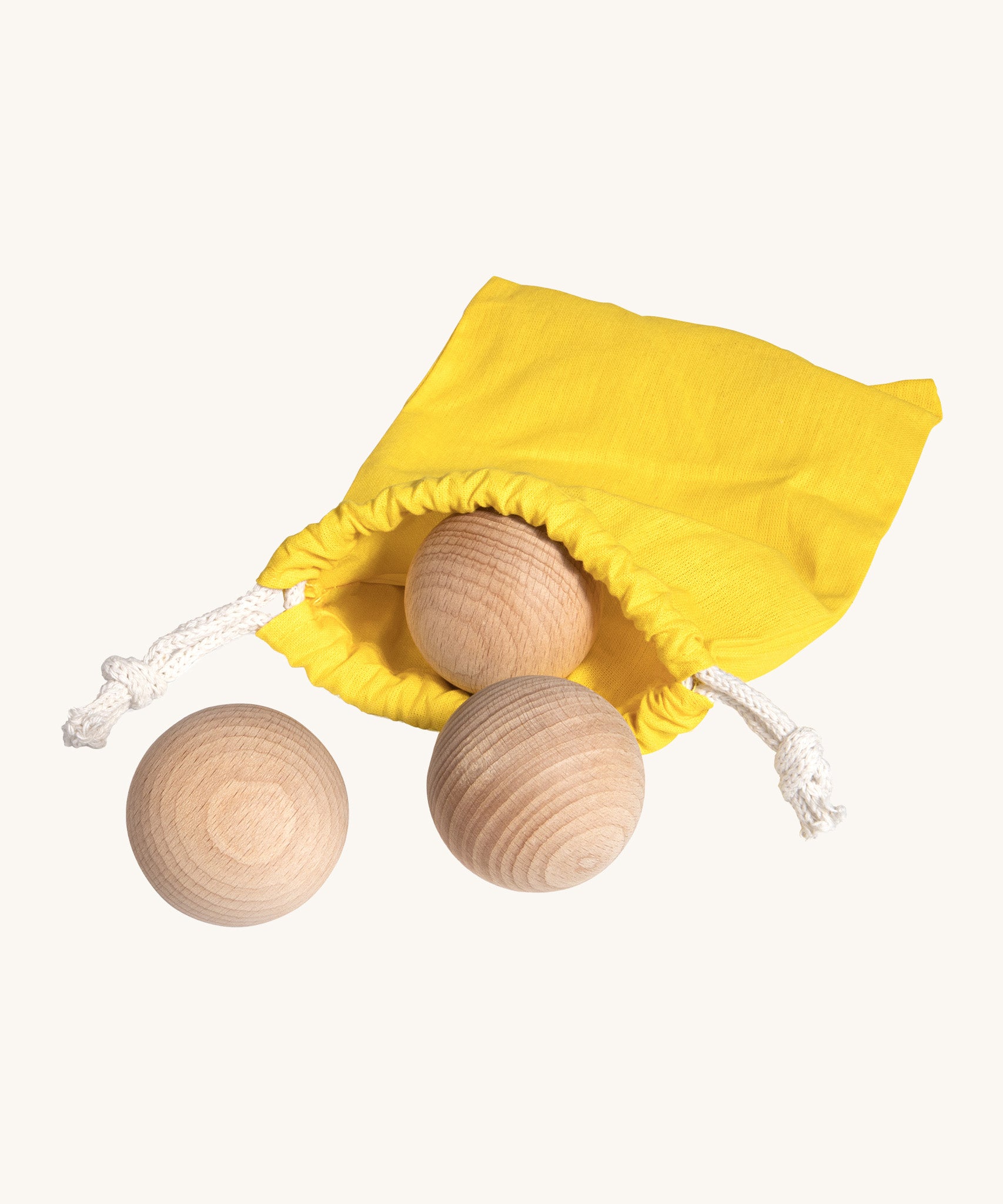 Erzi wooden outdoor marble set of 3 in a yellow pouch on a cream background.
