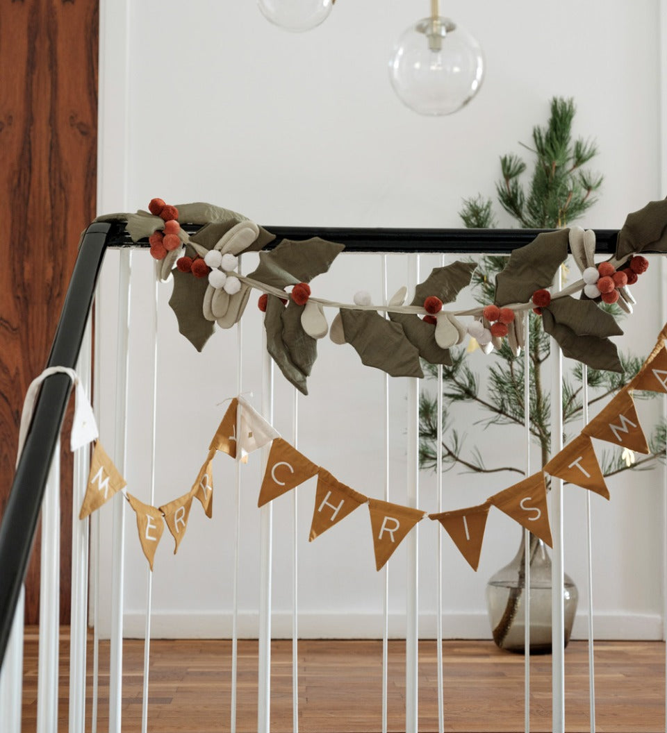 Fabelab eco-friendly reusable fabric garland hanging from some black and white bannisters