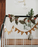 Fabelab eco-friendly reusable fabric garland hanging from some black and white bannisters