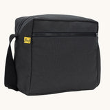 A side angle view of the black carbon coloured Fluf Crossbody Bag. The bag has a black coloured zip and crossbody strap.