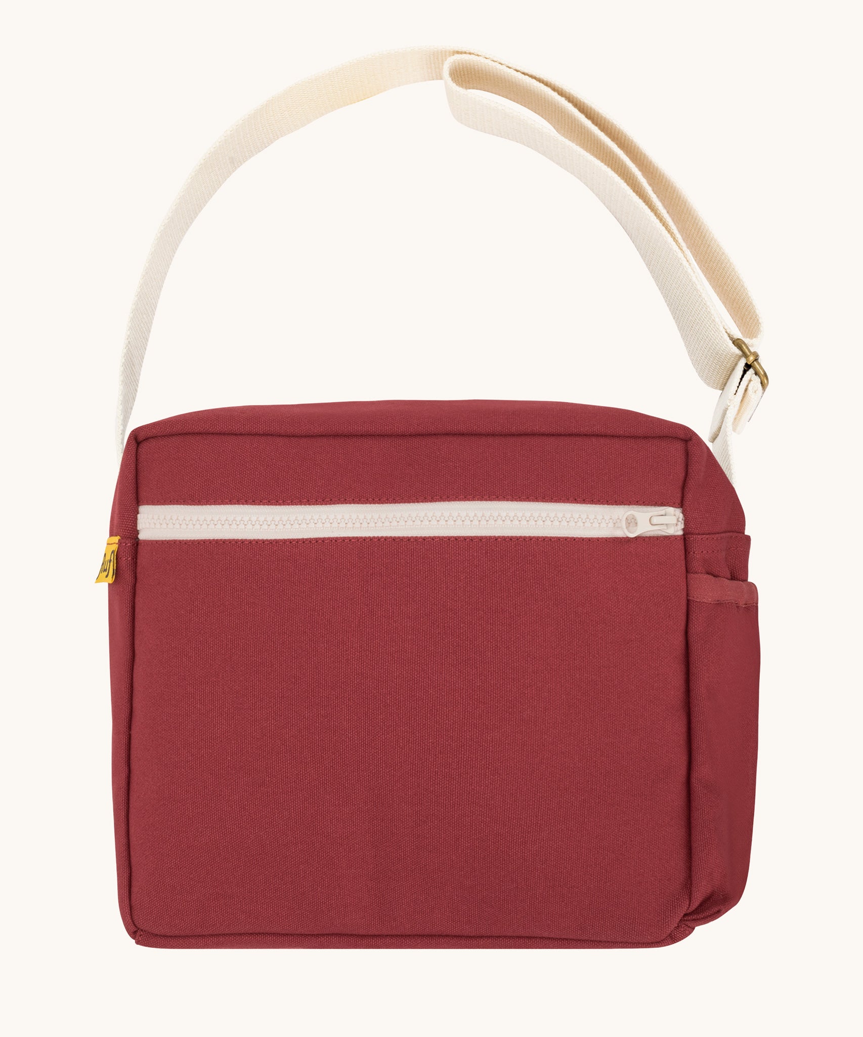 The classic vintage burgundy Fluf Crossbody Bag. The bag has and off white coloured zip an crossbody strap.