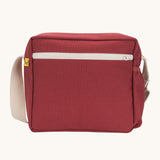 The vintage burgundy coloured Fluf Crossbody Bag. The bag has and off white coloured zip an crossbody strap.