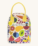 Fluf zip lunch bag in white with a design of different coloured fruits with a yellow handle and zip detail on a cream background.