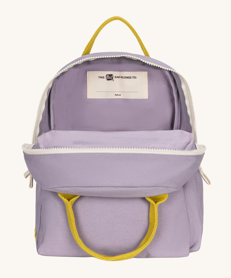 The organic cotton kids Fluf B-Pack Jr in lavender purple, the backpack is unzipped .