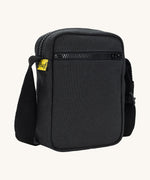 Sleek and compact Fluf Mini Crossbody Bag in black, organic cotton with recycled lining, machine washable, ideal for passports, keys and essentials on the go