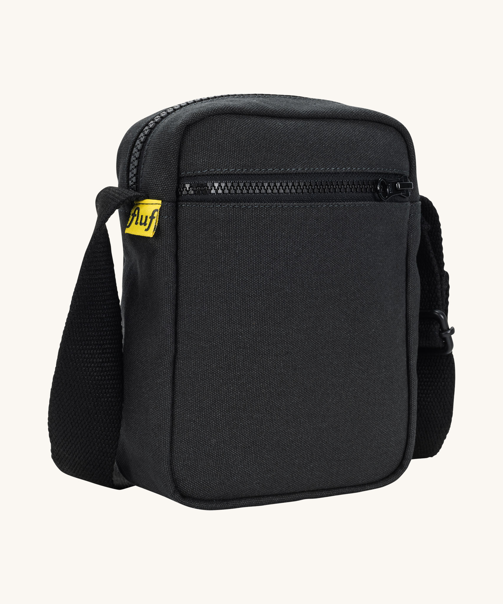 Sleek and compact Fluf Mini Crossbody Bag in black, organic cotton with recycled lining, machine washable, ideal for passports, keys and essentials on the go