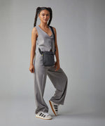 A woman in a trendy casual office wear suit, carrying the Fluf organic cotton mini crossbody bag in black