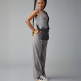 A woman in a trendy casual office wear suit, carrying the Fluf organic cotton mini crossbody bag in black