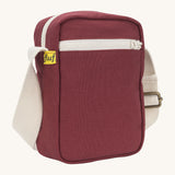 Sleek and compact Fluf Mini Crossbody Bag in burgundy, organic cotton with recycled lining, machine washable, ideal for passports, keys and essentials on the go